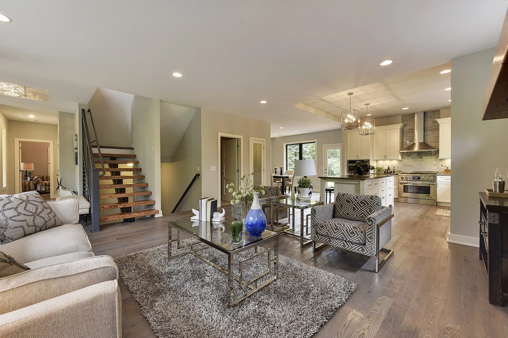 This is an example of a mid-sized contemporary formal open concept living room in Minneapolis with grey walls, medium hardwood floors, a standard fireplace, a metal fireplace surround, multi-coloured floor and no tv.