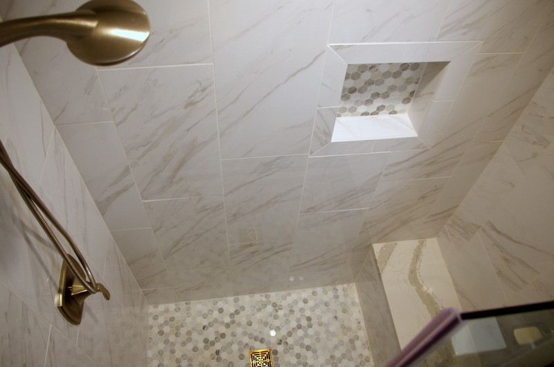 Small transitional master gray tile and porcelain tile porcelain tile and brown floor alcove shower photo in Chicago with shaker cabinets, dark wood cabinets, a one-piece toilet, gray walls, an undermount sink and quartz countertops