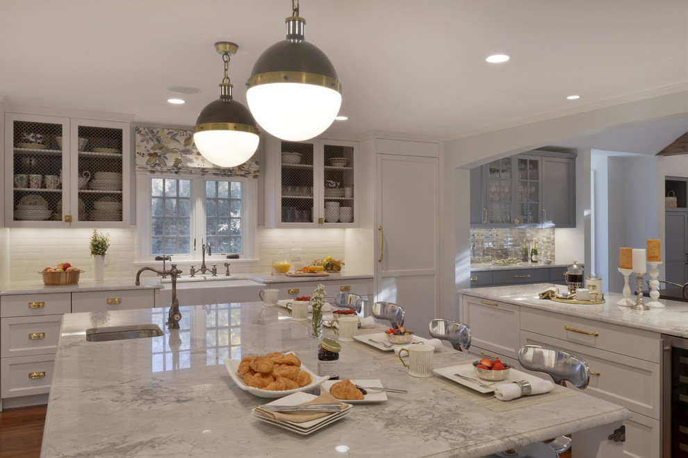 Huge transitional l-shaped dark wood floor eat-in kitchen photo in New York with a farmhouse sink, recessed-panel cabinets, white cabinets, quartzite countertops, white backsplash, ceramic backsplash, colored appliances and two islands