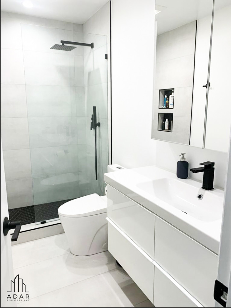 Mid-sized modern kids bathroom in Los Angeles with flat-panel cabinets, white cabinets, an alcove shower, white walls, marble floors, an integrated sink, marble benchtops, white floor, white benchtops, a single vanity and a built-in vanity.