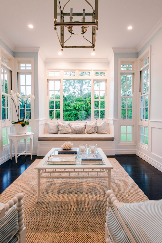 Photo of a mid-sized country open concept living room in Brisbane with blue walls and dark hardwood floors.