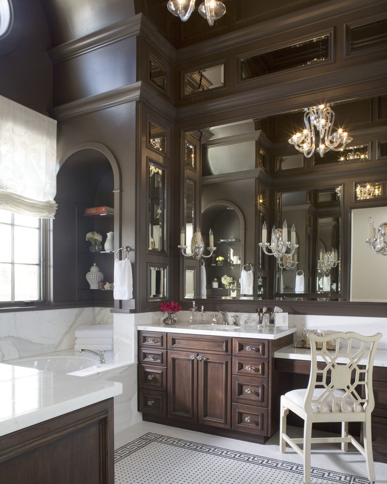 Design ideas for a traditional bathroom in Denver with dark wood cabinets and an alcove tub.
