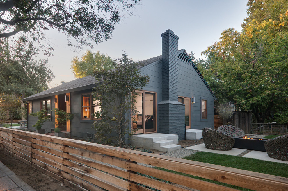 Photo of a mid-sized transitional one-storey grey exterior in Sacramento with wood siding and a gable roof.