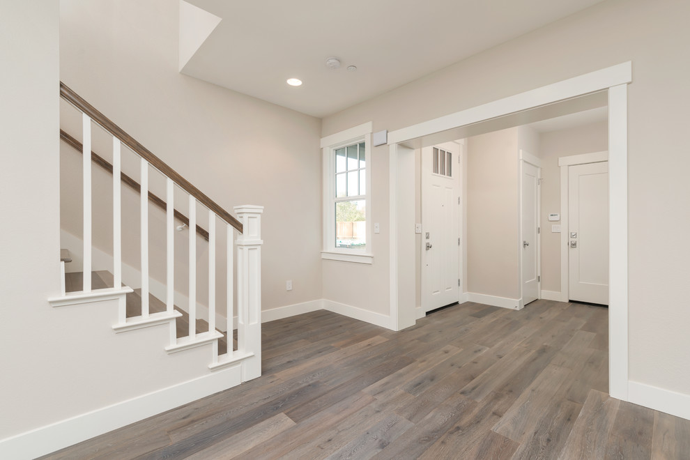 Arts and crafts medium tone wood floor front door photo in San Francisco with beige walls and a white front door