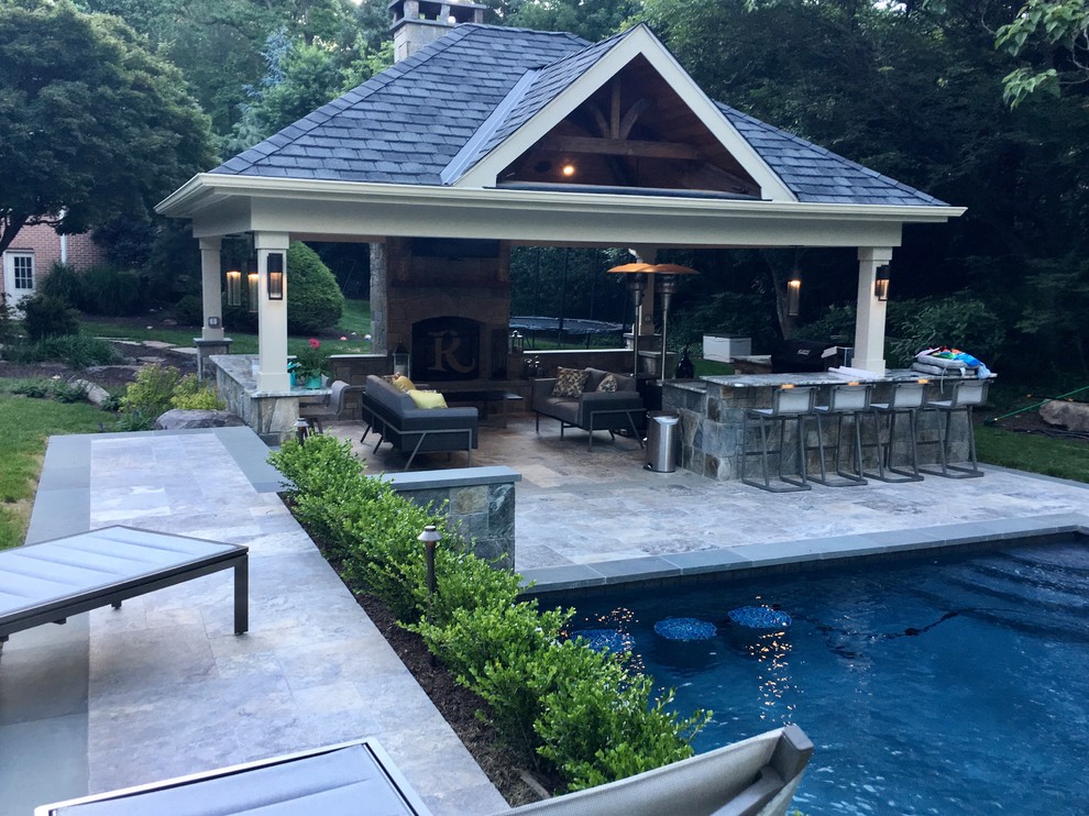 This is an example of a mid-sized traditional backyard patio in DC Metro with a fire feature, tile and a gazebo/cabana.