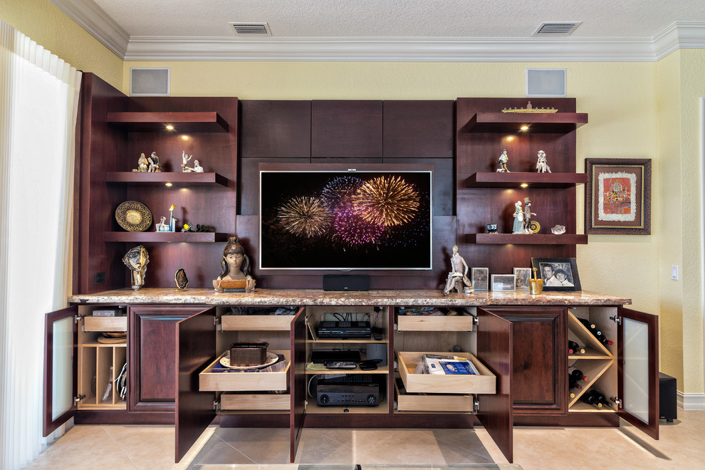 Large transitional open concept travertine floor home design photo in Miami with a media wall and yellow walls