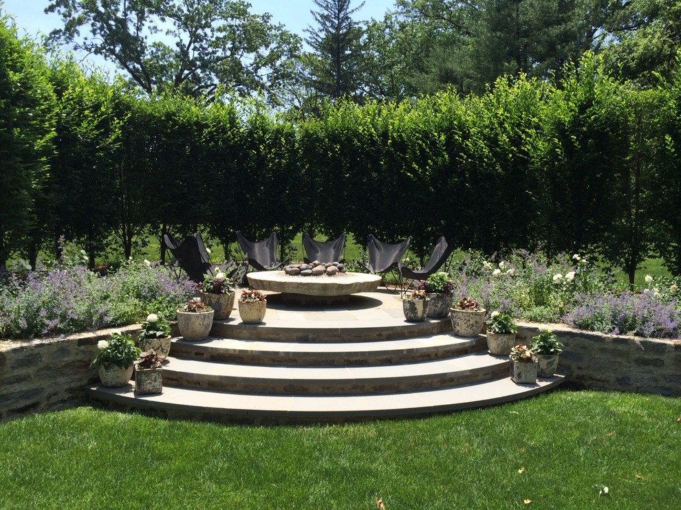 Inspiration for a large traditional backyard partial sun garden for spring in Philadelphia with a fire feature and natural stone pavers.