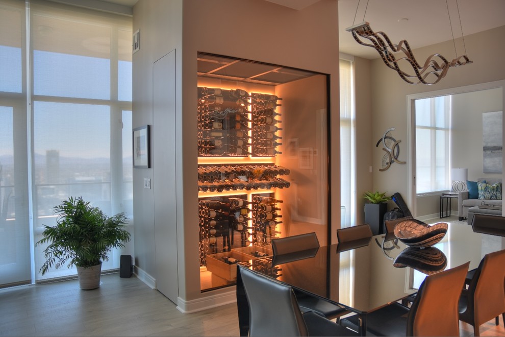 Inspiration for a small contemporary wine cellar in San Diego with light hardwood floors and display racks.
