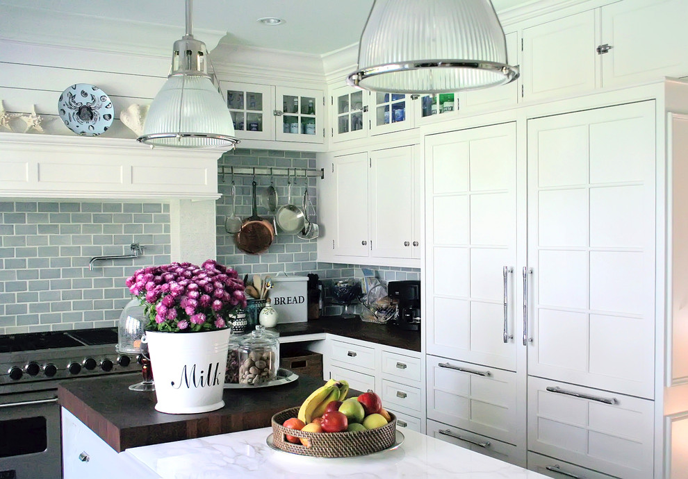 Design ideas for a traditional kitchen in New York with shaker cabinets, white cabinets, blue splashback, subway tile splashback, marble benchtops and panelled appliances.