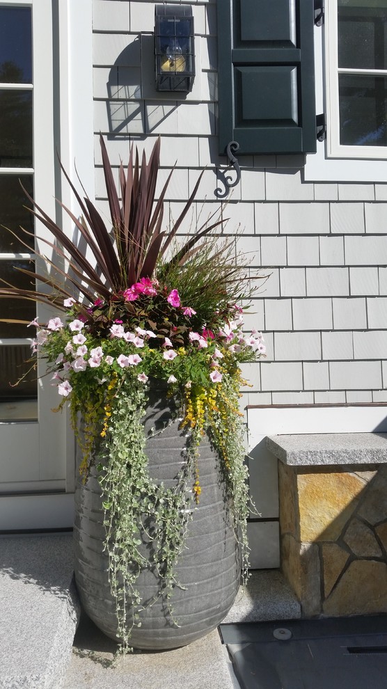 Small farmhouse front porch idea in Portland Maine with decking