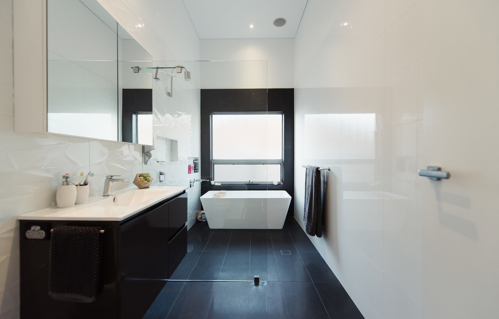 Inspiration for a large contemporary kids bathroom in Adelaide with a freestanding tub, an open shower, a one-piece toilet, white tile, ceramic tile, white walls, ceramic floors, an integrated sink, grey floor, an open shower and dark wood cabinets.