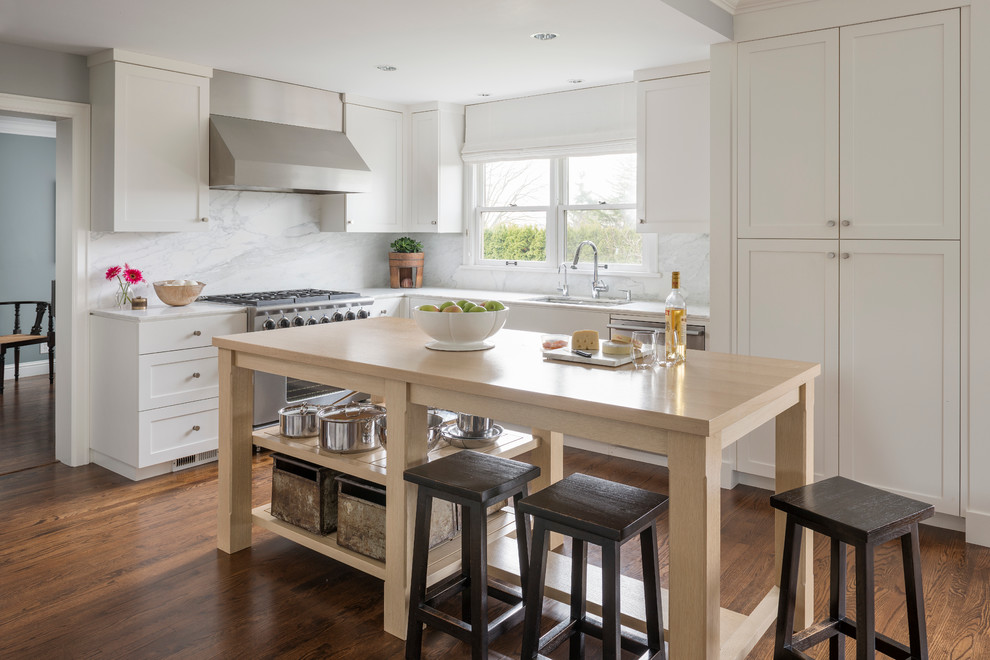 Traditional l-shaped kitchen in Seattle with an undermount sink, recessed-panel cabinets, white cabinets, white splashback, stainless steel appliances and dark hardwood floors.