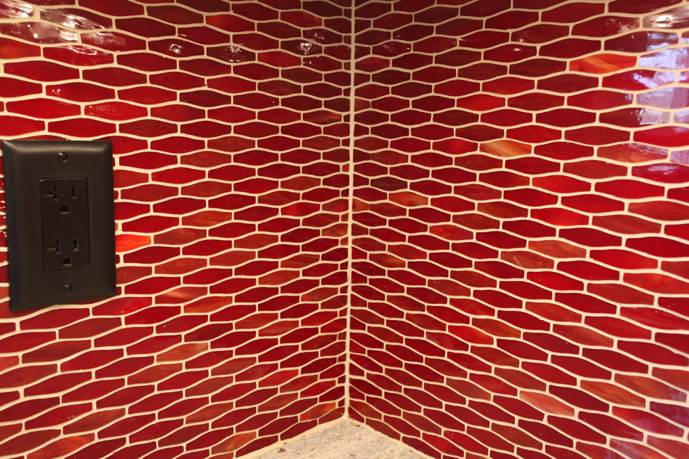 Transitional ceramic tile kitchen photo in New York with an undermount sink, shaker cabinets, light wood cabinets, granite countertops, red backsplash, ceramic backsplash and stainless steel appliances