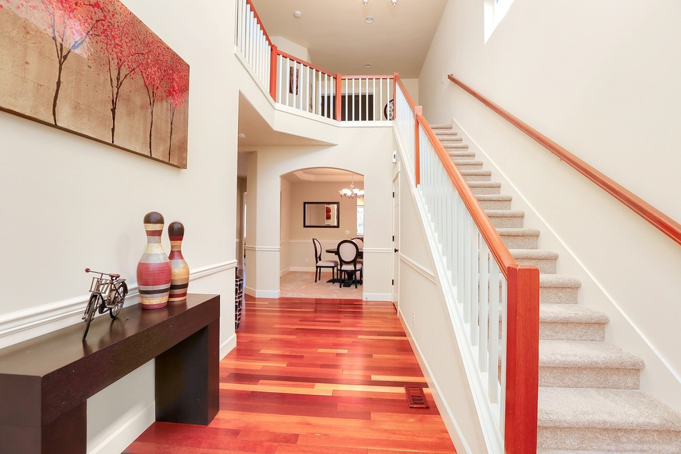 Photo of a mid-sized contemporary hallway in Seattle with white walls, medium hardwood floors and brown floor.