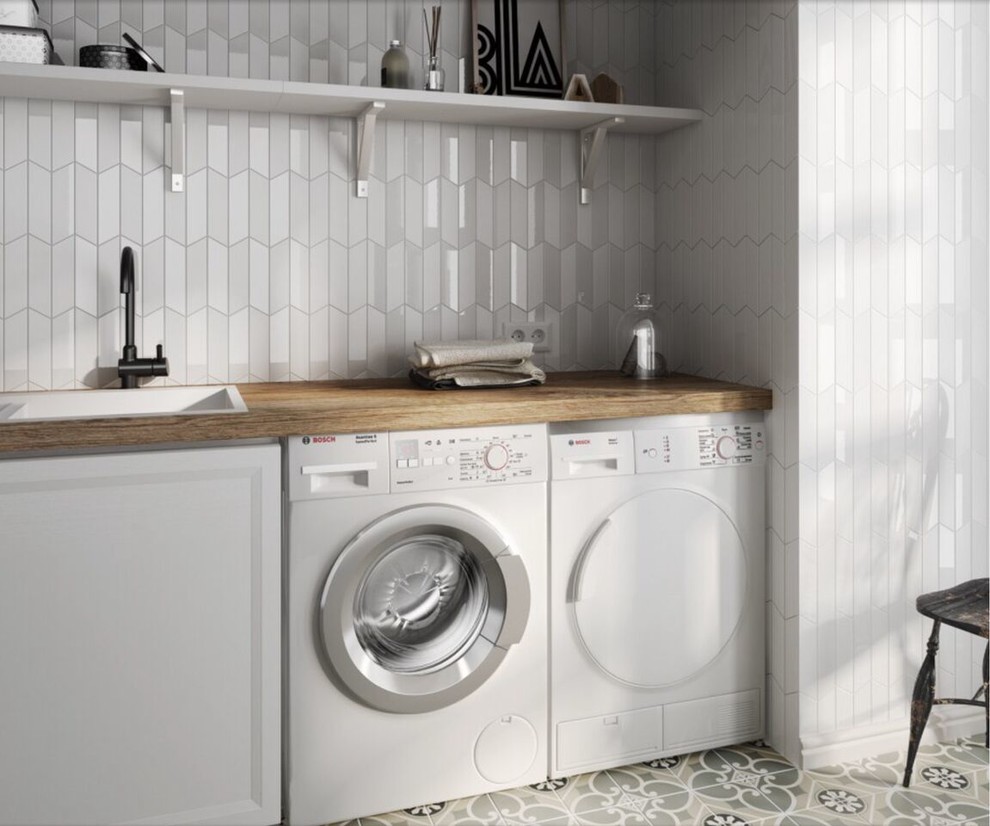 Inspiration for a mid-sized transitional single-wall dedicated laundry room in Sydney with a single-bowl sink, shaker cabinets, white cabinets, wood benchtops, grey walls and a side-by-side washer and dryer.