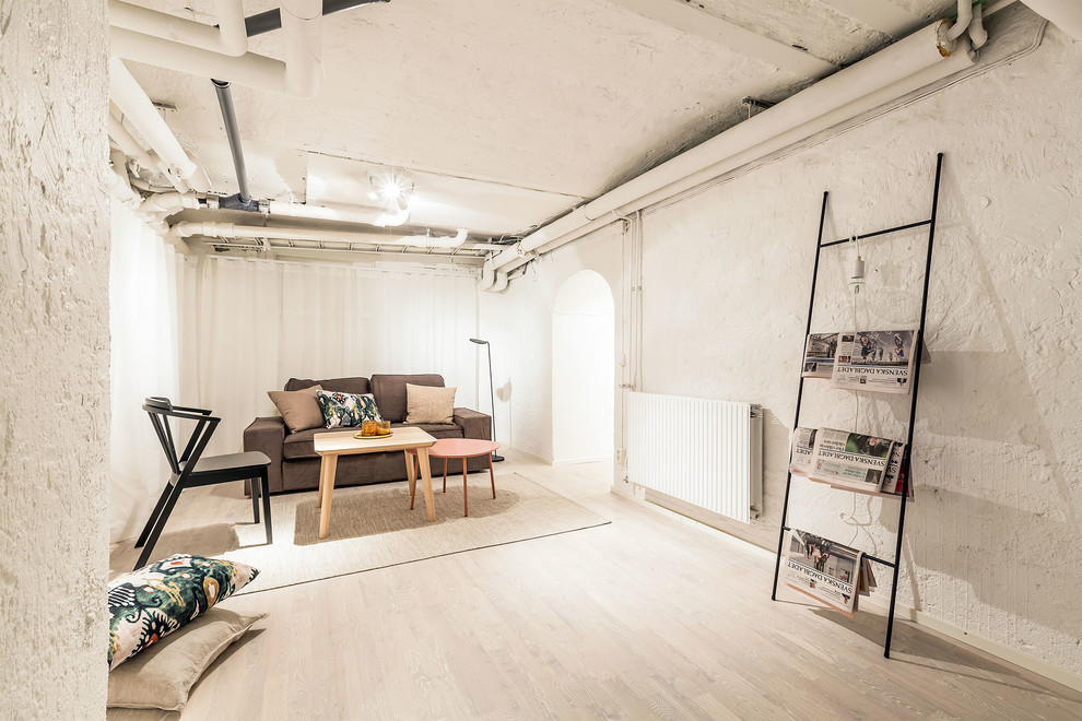 Mid-sized scandinavian open concept living room in Stockholm with white walls, light hardwood floors and no fireplace.