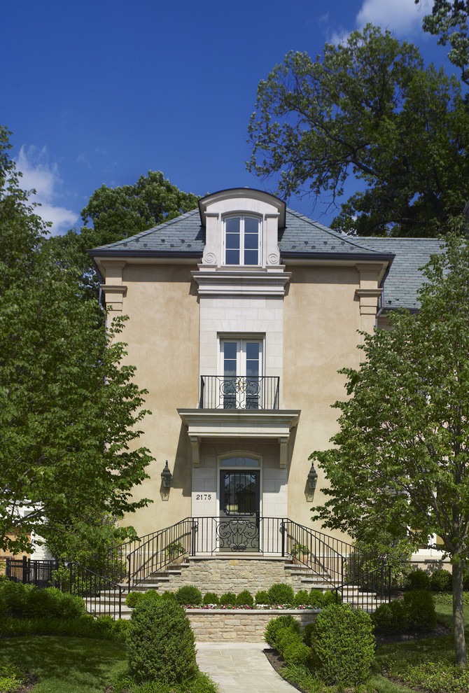 This is an example of a mediterranean three-storey stucco beige exterior in DC Metro.