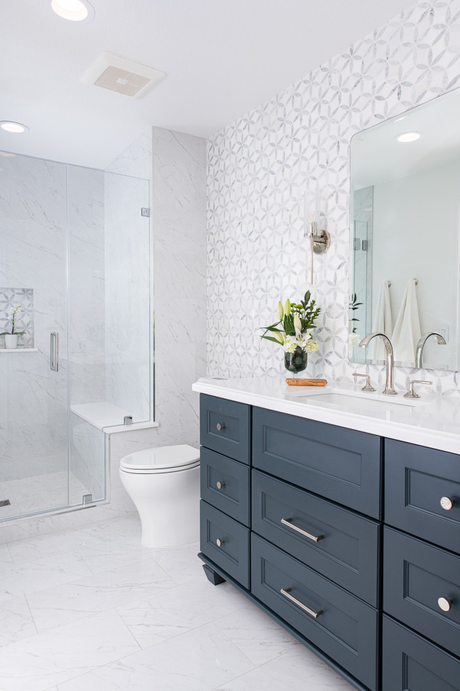 Design ideas for a transitional 3/4 bathroom in Orange County with shaker cabinets, turquoise cabinets, a one-piece toilet, white tile, marble, white walls, porcelain floors, an undermount sink, quartzite benchtops, white floor, a hinged shower door, white benchtops, a niche, a single vanity and a freestanding vanity.