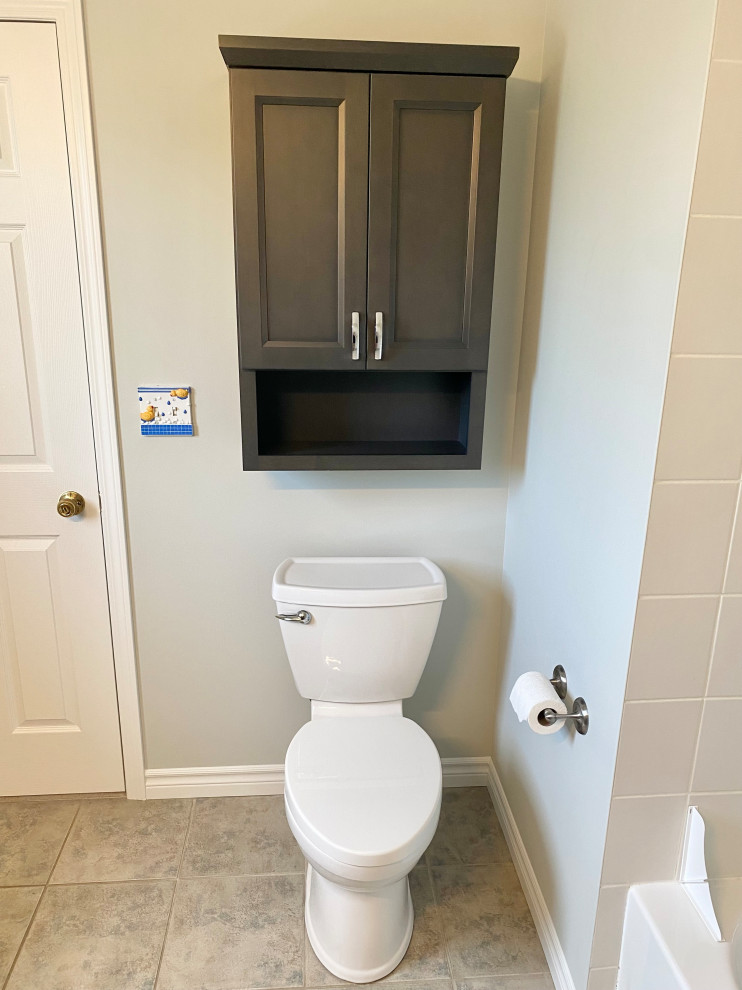 Transitional 3/4 porcelain tile, gray floor and single-sink bathroom photo with recessed-panel cabinets, a one-piece toilet, gray walls, an undermount sink, quartzite countertops, white countertops and a built-in vanity