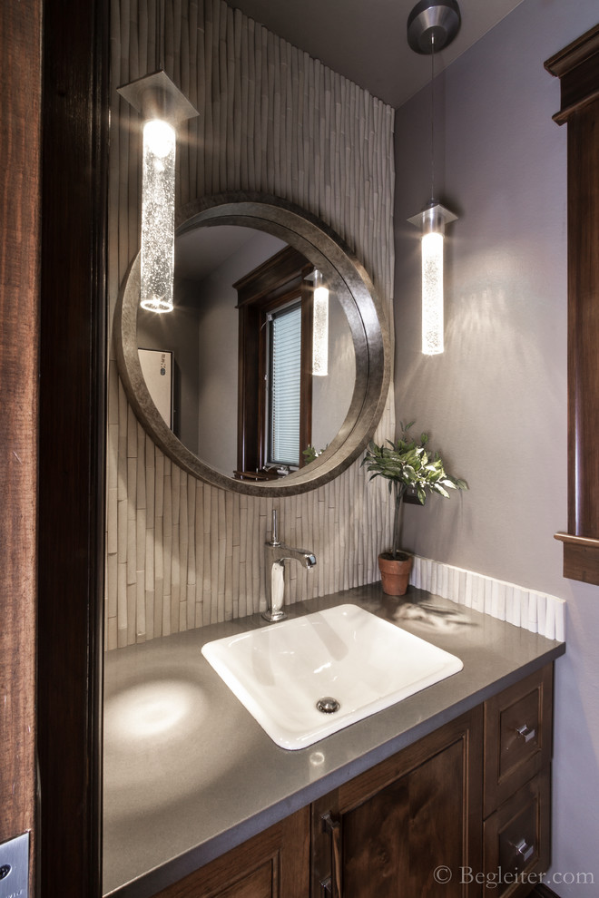 Inspiration for a small transitional powder room in Other with furniture-like cabinets, medium wood cabinets, a one-piece toilet, beige tile, matchstick tile, grey walls, a drop-in sink and engineered quartz benchtops.