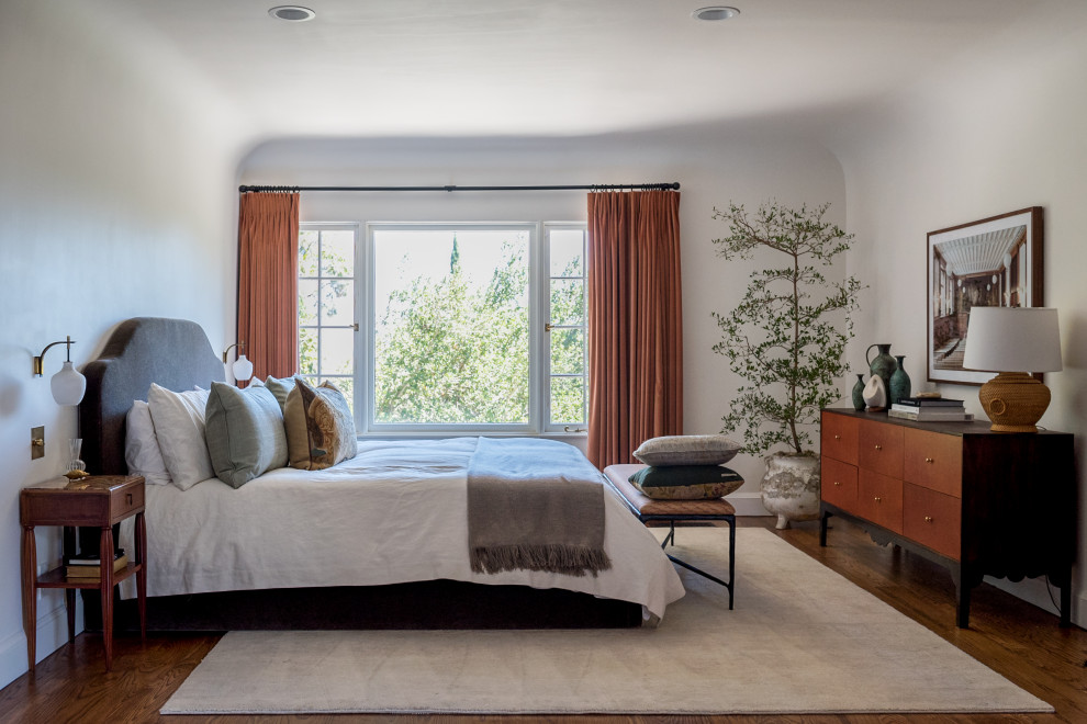 Tuscan dark wood floor and brown floor bedroom photo in Tampa with white walls