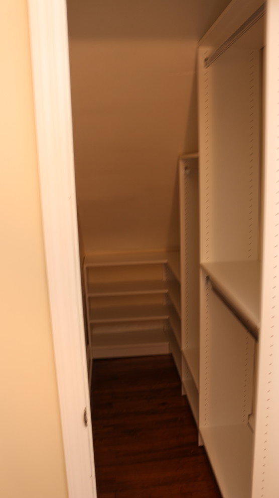 This is an example of a small contemporary gender-neutral walk-in wardrobe in New York.