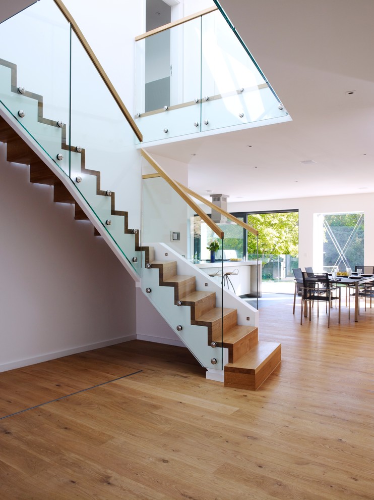 Inspiration for a large contemporary wood curved staircase in Other with wood risers.