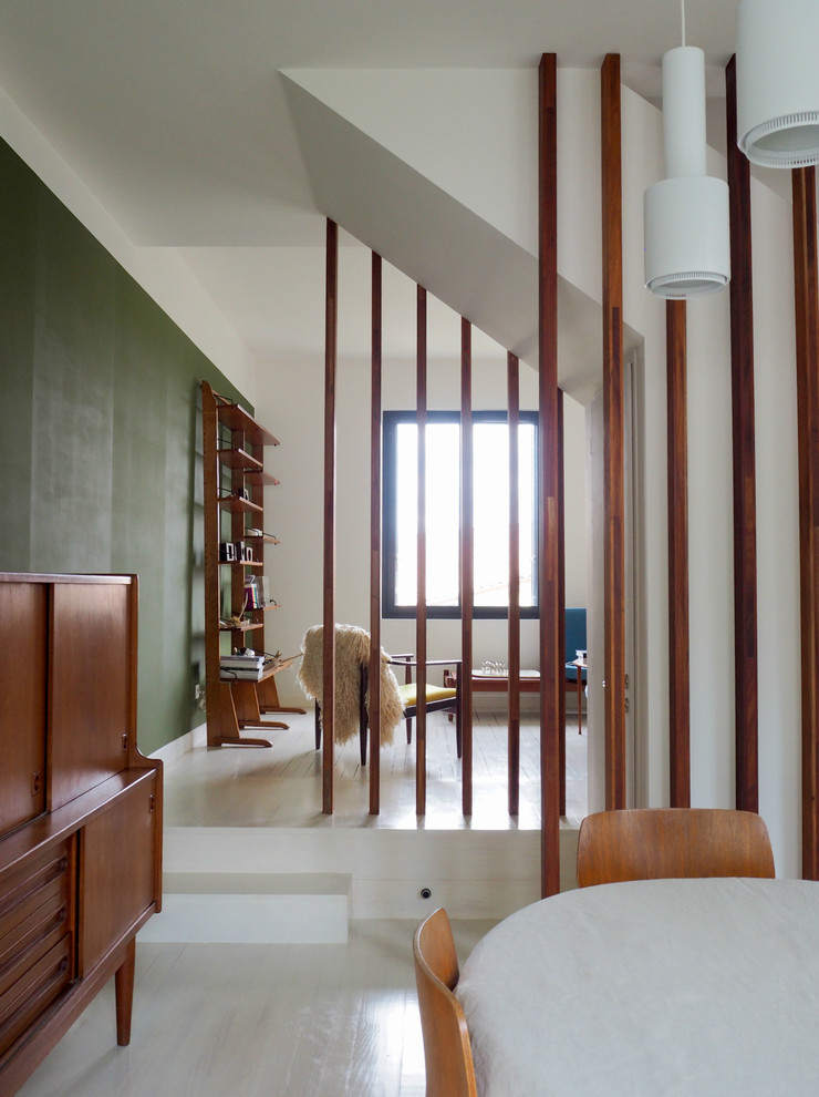 Inspiration for a contemporary open concept family room in Toulouse with green walls and painted wood floors.