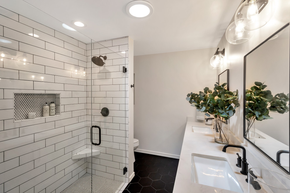 This is an example of a mid-sized transitional master bathroom in Phoenix with shaker cabinets, white cabinets, a freestanding tub, a curbless shower, white tile, subway tile, porcelain floors, an undermount sink, engineered quartz benchtops, black floor, a hinged shower door, white benchtops, a niche, a double vanity and a built-in vanity.