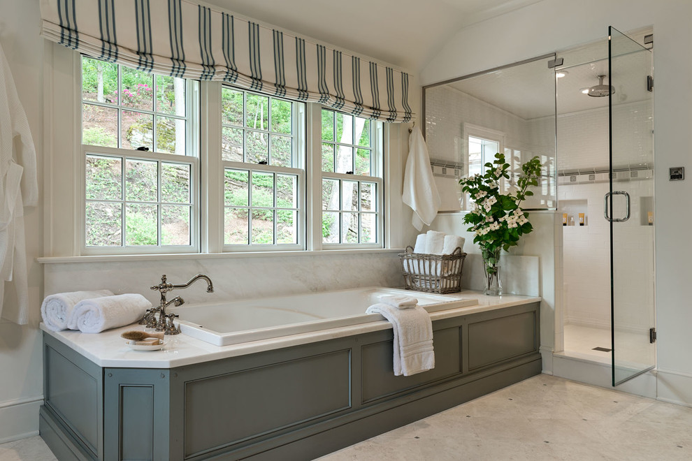 Design ideas for a large country master bathroom in New York with shaker cabinets, green cabinets, a drop-in tub, an alcove shower, white walls, ceramic floors, an undermount sink, marble benchtops, beige floor and a hinged shower door.