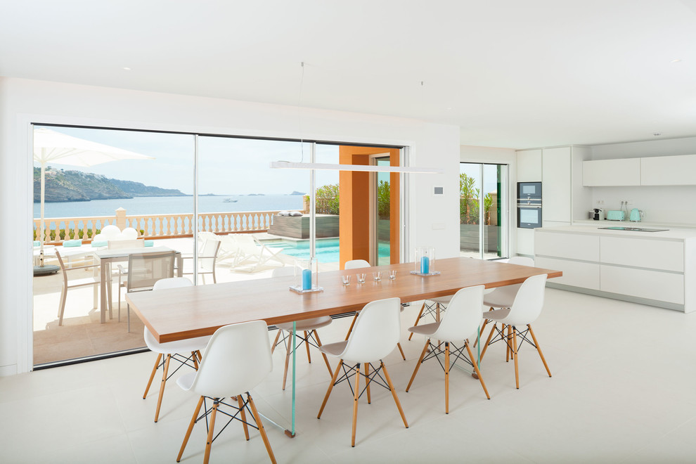 Photo of a contemporary open plan dining in Palma de Mallorca with white walls and white floor.