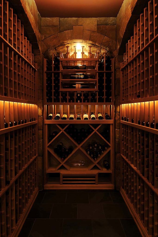 Inspiration for a mid-sized rustic porcelain tile and gray floor wine cellar remodel in Chicago with storage racks