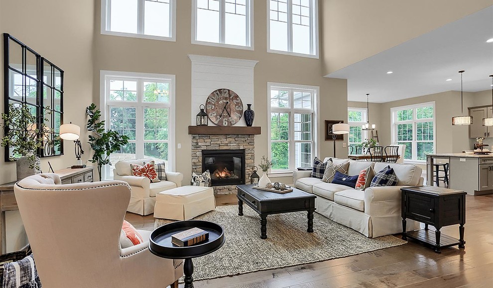 Design ideas for an expansive traditional open concept family room in Other with grey walls, light hardwood floors, a standard fireplace and a stone fireplace surround.
