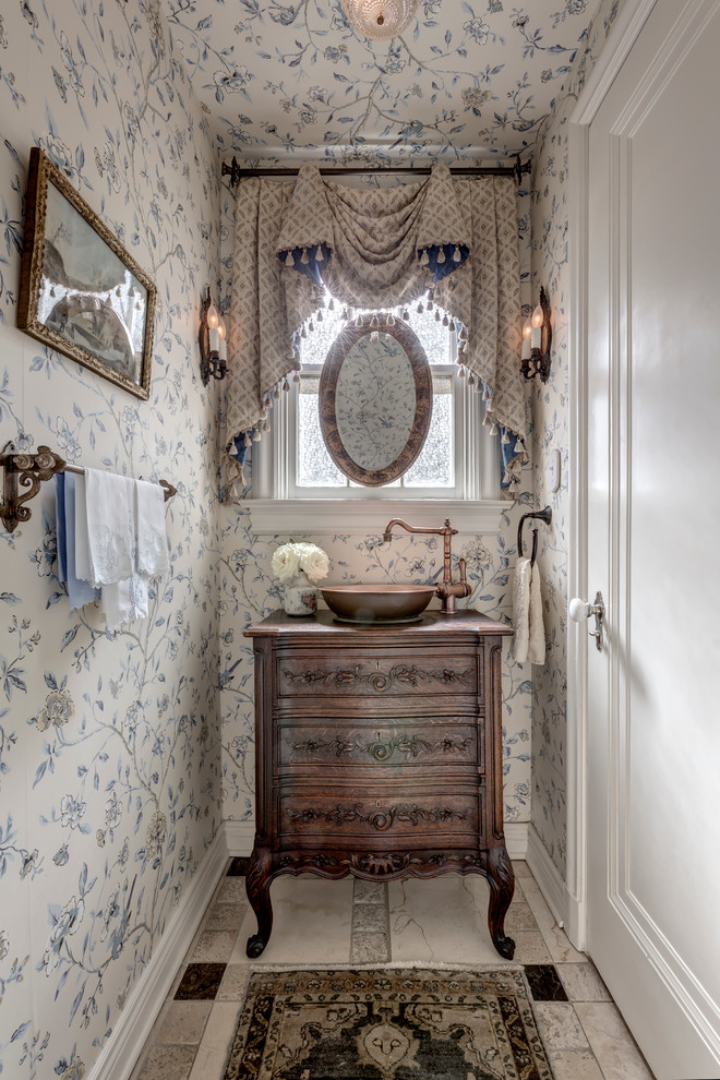 Inspiration for a small traditional powder room in Dallas with a vessel sink, dark wood cabinets and furniture-like cabinets.