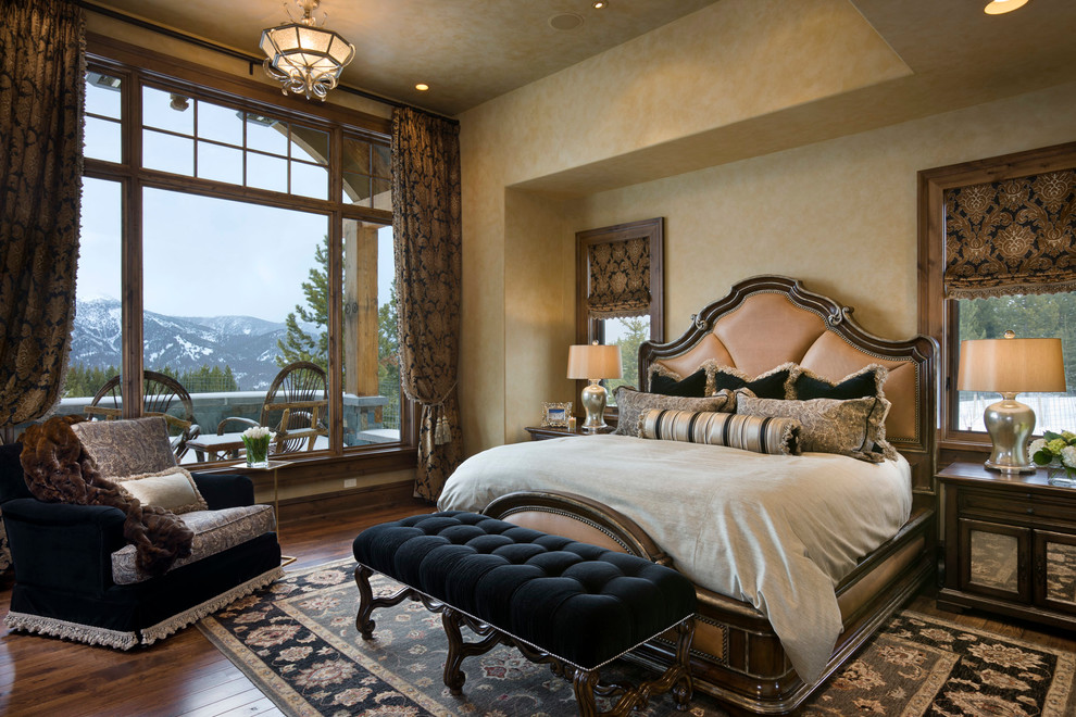Design ideas for a traditional bedroom in Other with beige walls and dark hardwood floors.