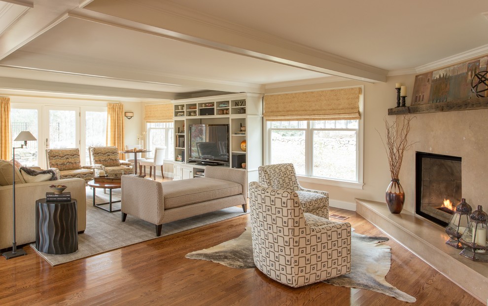 Photo of a large transitional open concept living room in Boston with beige walls, medium hardwood floors, a corner fireplace, a stone fireplace surround and a built-in media wall.