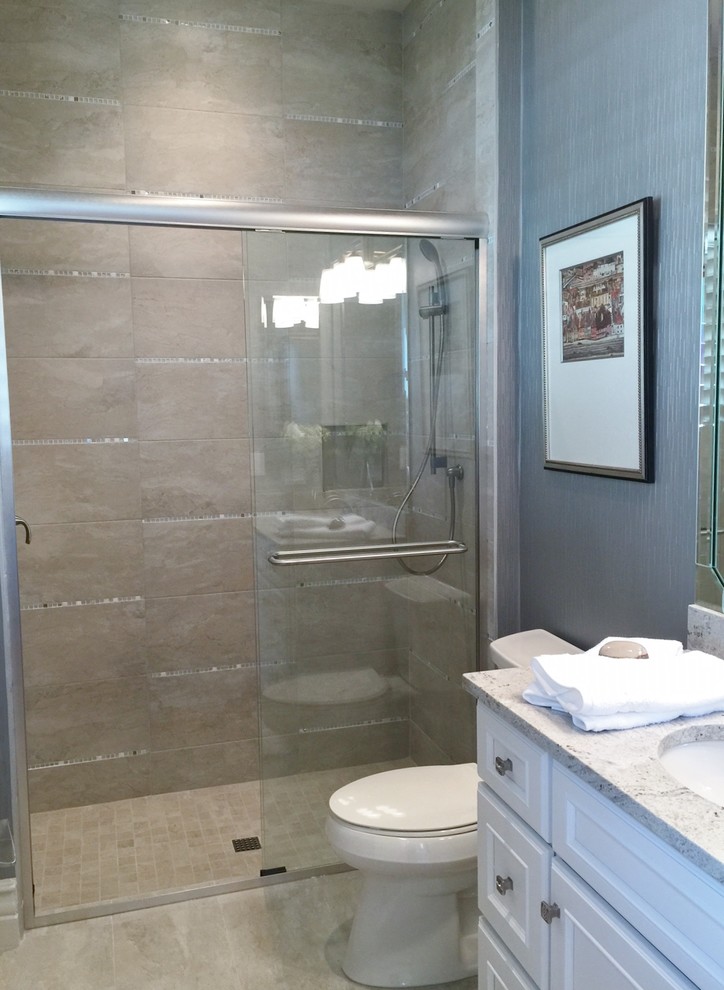 Large transitional 3/4 bathroom in Miami with a drop-in sink, shaker cabinets, white cabinets, granite benchtops, an open shower, a one-piece toilet, beige tile, porcelain tile, blue walls and porcelain floors.