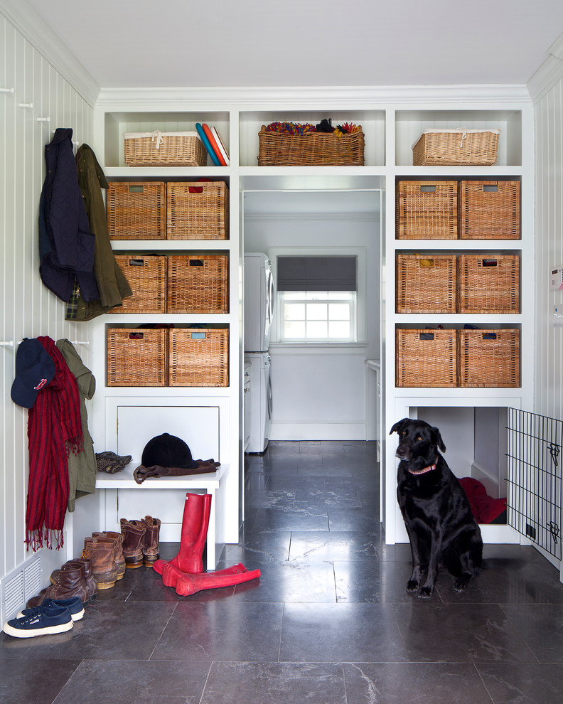 Photo of a mid-sized transitional mudroom in New York with white walls, limestone floors and a single front door.