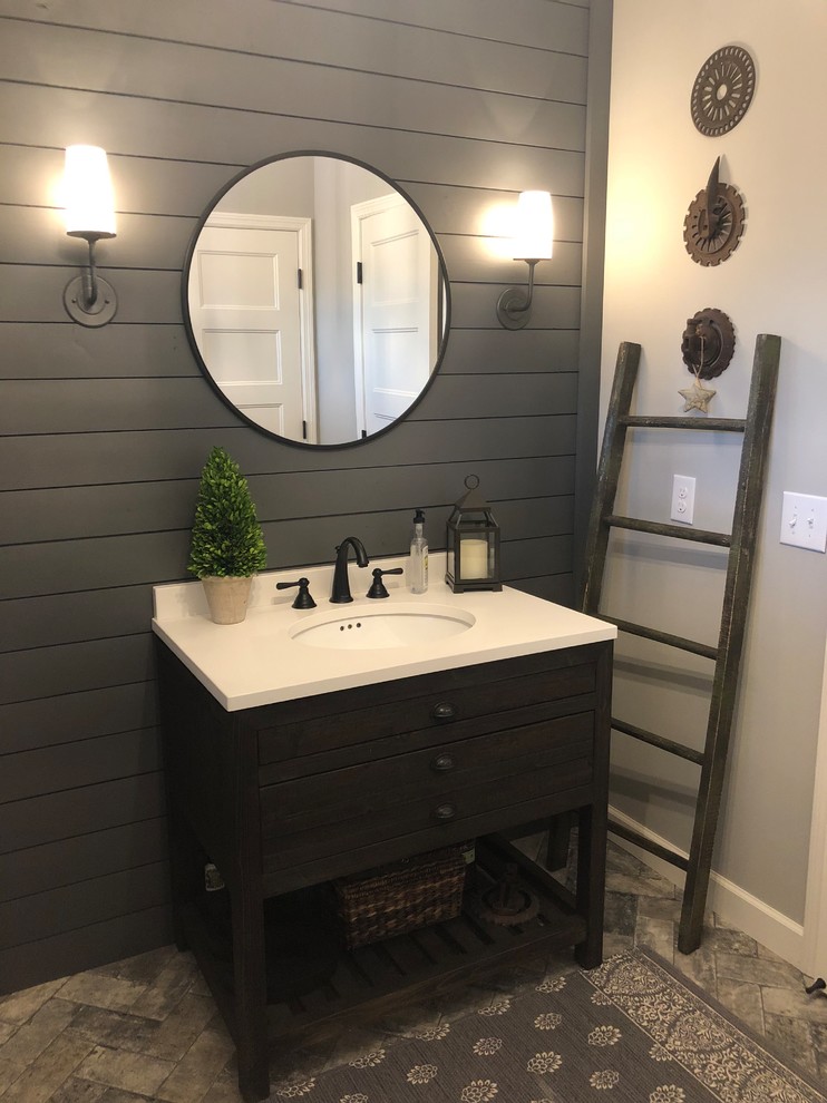 Design ideas for a mid-sized transitional powder room in Minneapolis with open cabinets, dark wood cabinets, grey walls, brick floors, a console sink, solid surface benchtops, multi-coloured floor and white benchtops.