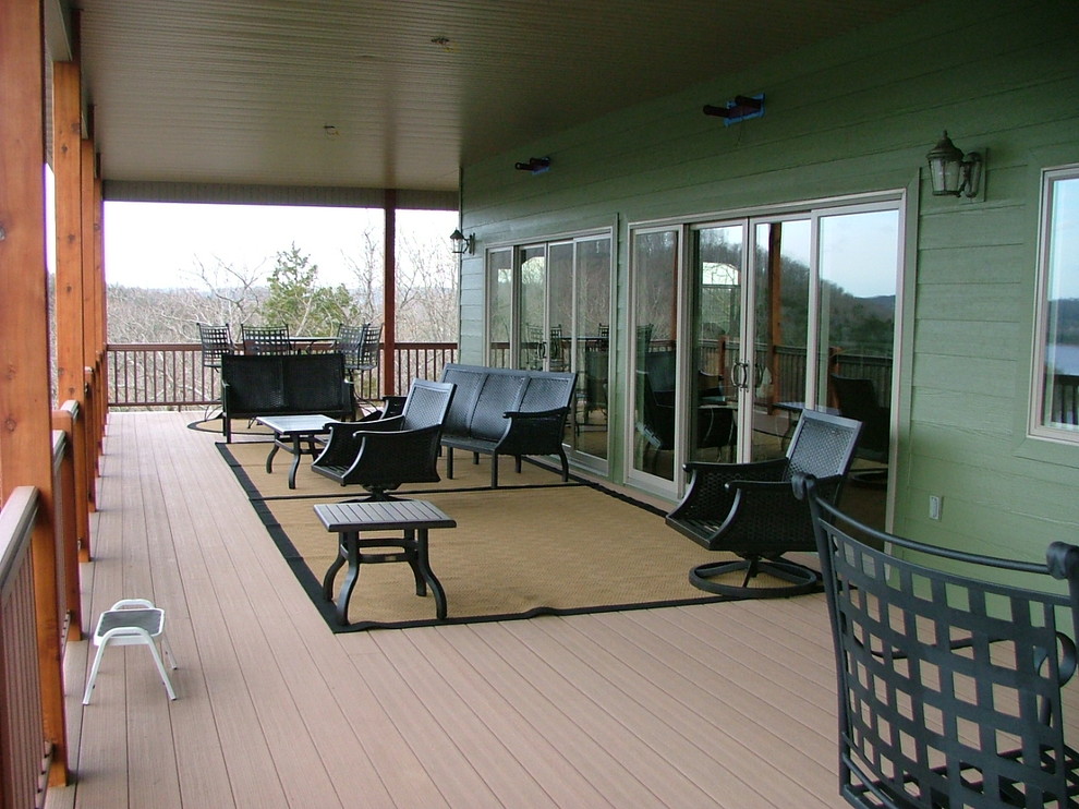 Inspiration for a mid-sized rustic backyard outdoor kitchen deck remodel with a roof extension