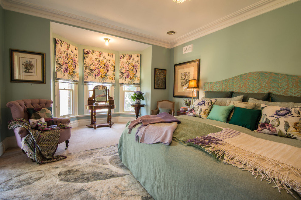 Inspiration for a large traditional master bedroom in Melbourne with green walls and carpet.