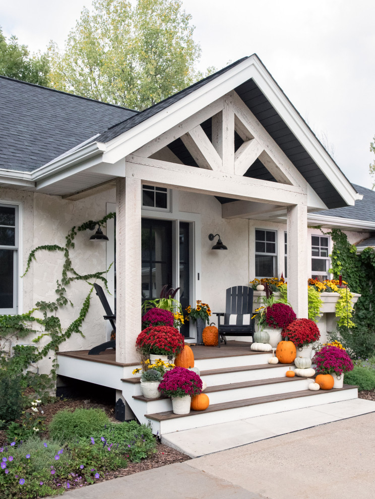 Mid-sized country front porch idea in Minneapolis with decking and a roof extension
