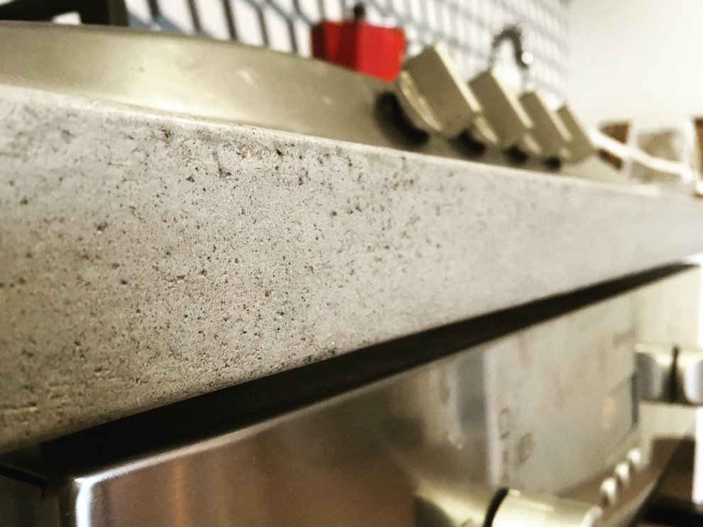 Inspiration for an industrial kitchen in London with cement tile splashback and stainless steel appliances.