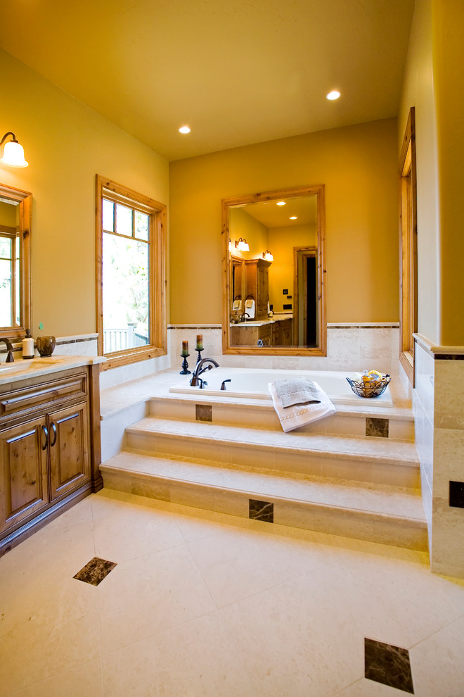 Inspiration for a large country master bathroom in Other with raised-panel cabinets, medium wood cabinets, a drop-in tub, an alcove shower, white tile, porcelain tile, beige walls, porcelain floors and marble benchtops.