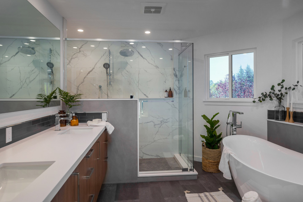 Photo of a medium sized traditional ensuite bathroom in San Francisco with shaker cabinets, brown cabinets, a freestanding bath, a double shower, a bidet, white tiles, porcelain tiles, white walls, vinyl flooring, a submerged sink, quartz worktops, brown floors, a hinged door, white worktops, a wall niche, double sinks, a built in vanity unit and a vaulted ceiling.