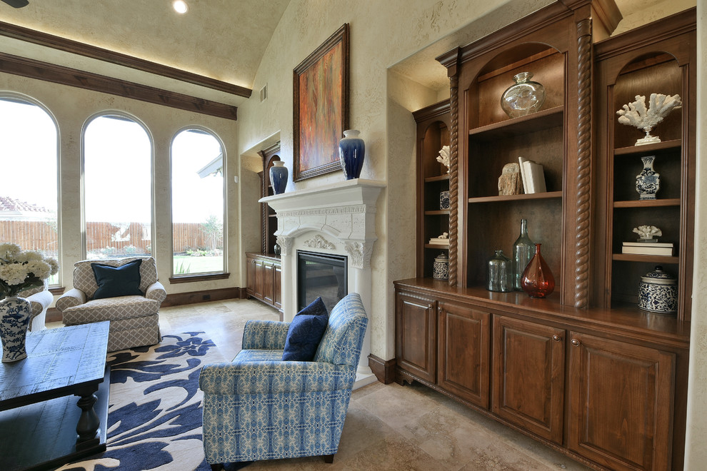 Photo of a large mediterranean open concept living room in Houston with beige walls, travertine floors, a standard fireplace, a stone fireplace surround, no tv and beige floor.