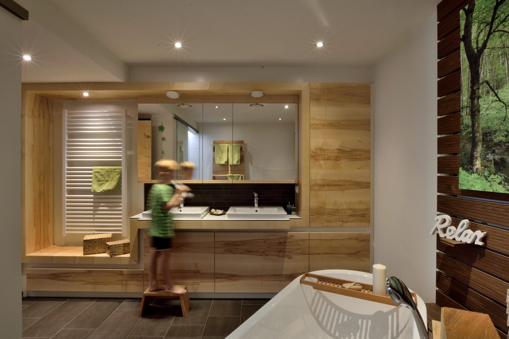 Contemporary bathroom in Other with flat-panel cabinets, light wood cabinets, glass benchtops and white benchtops.