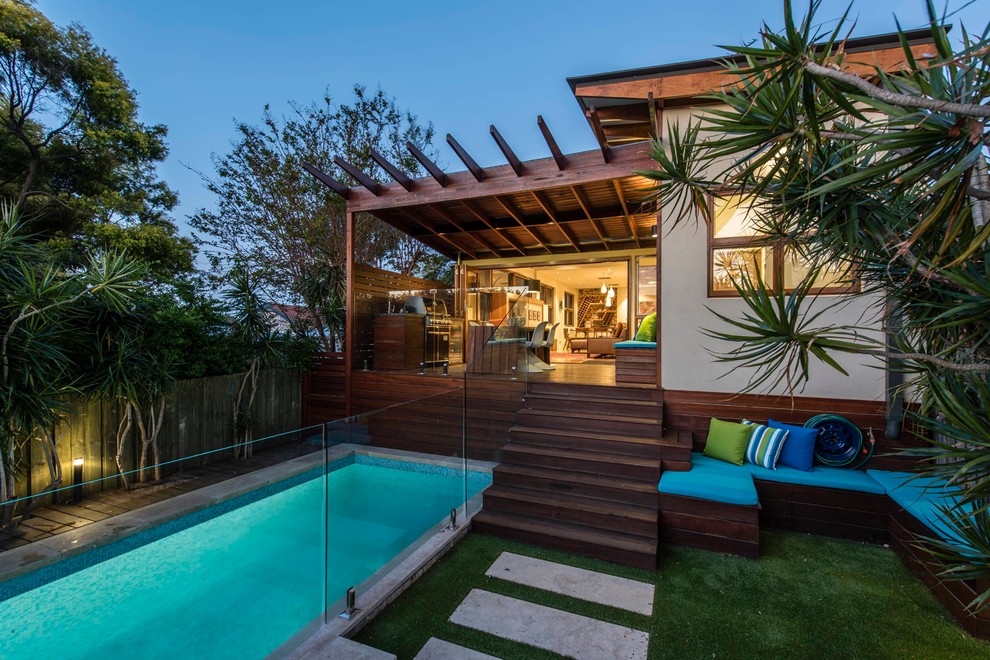 Photo of a small contemporary backyard rectangular lap pool in Sydney with concrete pavers.