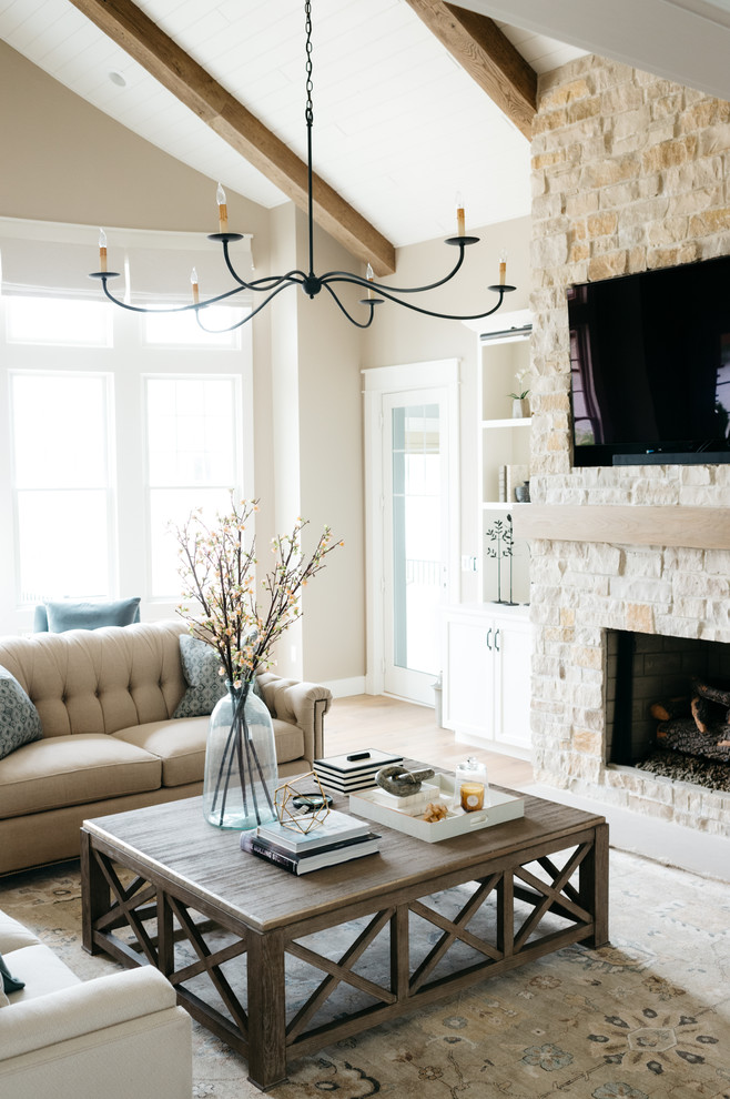 Family room - large farmhouse enclosed light wood floor and brown floor family room idea in Detroit with beige walls, a standard fireplace, a stone fireplace and a media wall