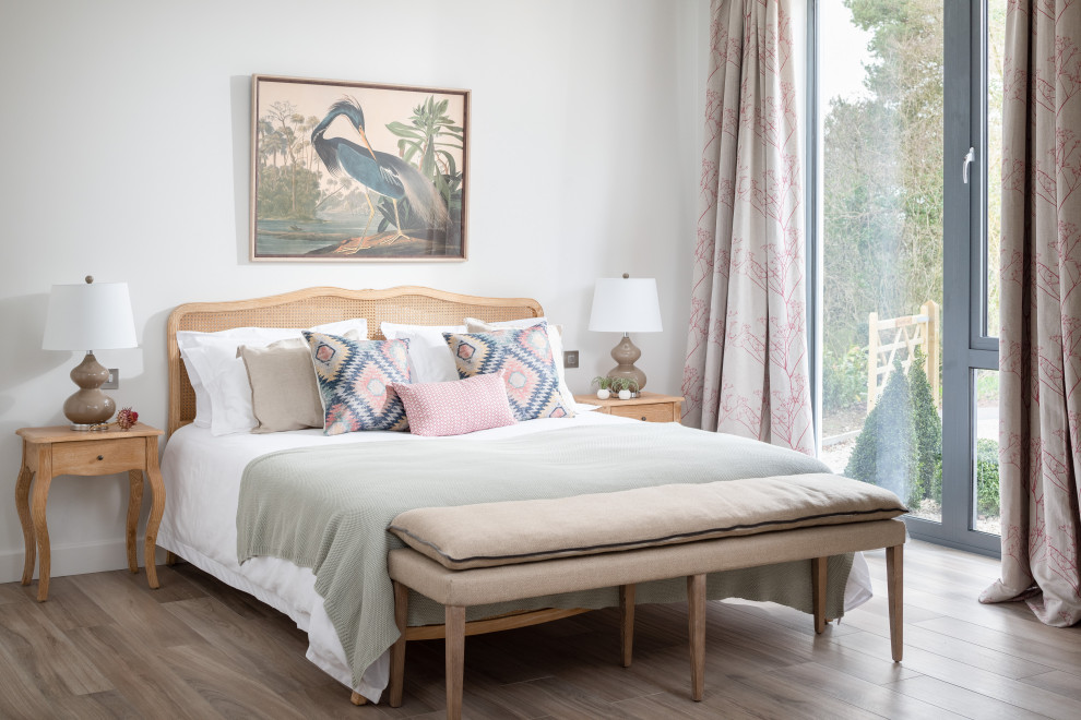 Medium sized nautical guest bedroom in Dorset with white walls and light hardwood flooring.